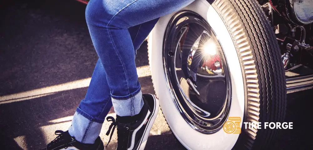 women seating on a whitewall tire