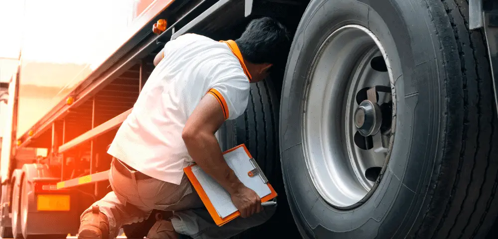 Man checking truck tires