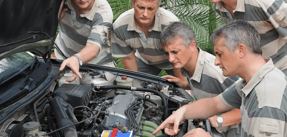 A group of men looking at a car engine